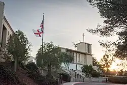 Church building with trees and flag