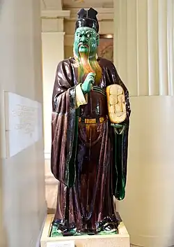 Stoneware figure from a judgement group, holding records of evil deeds. From China, Ming Dynasty, 16th century CE. The British Museum.