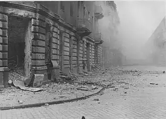 NARA copy #46, IPN copy #46 (No image caption, in section This is how the former Ghetto looks after having been destroyed) Ulica Kupiecka Street viewed from Zamenhofa, with Zamenhofa 42 / Kupiecka 18 on the left.
