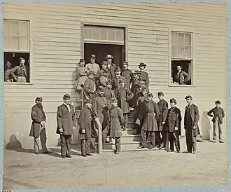 a group of hospital stewards and surgeons in uniform standing outside of a hospital.