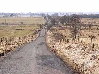 Country lane disappearing over the horizon