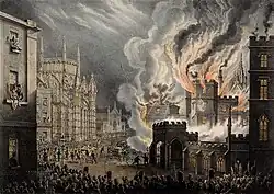 View of the front of the Palace of Westminster on fire, seen from Abingdon Street. Crowds—seen at the bottom of the image—are being held back by soldiers, while firemen can be seen tackling the blaze