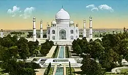 The typical view of the Taj Mahal from the pool axis, but trees on both sides of the pool and its walkways. The photograph is handcoloured.