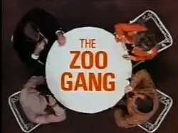 Series title over an image of the characters seated at a table