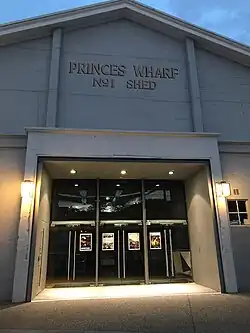 grey building with some lights at the entrance