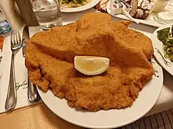 The pork schnitzel at the Figlmuller restaurant in Vienna, served with lemon.