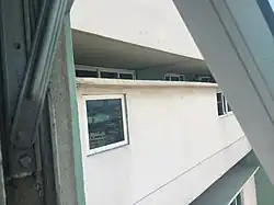 20 in (510 mm) separation between corridors showing apartment windows.