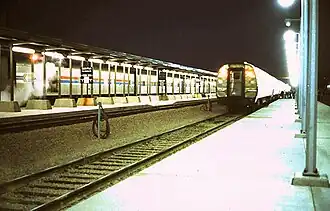 Westbound North Coast Hiawatha (left) and eastbound North Star (right) meet at Midway station, May 1978