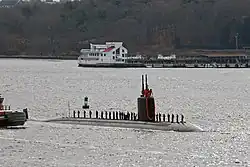 Sailors man the rails as the submarine transits the Thames River en route to Naval Submarine Base New London after an eight-month deployment. (2 December 2009)