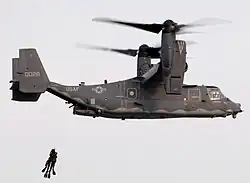SEALs being hoisted into a CV-22 Osprey from the Air Force's 8th Special Operations Squadron during a joint training exercise.