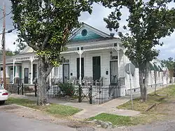 A double shotgun structure in the Uptown section of New Orleans. Double shotgun houses were a form of multiple-family housing, where essentially two conventional shotgun houses shared a central wall.
