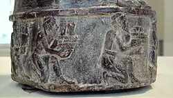 Tribute bearers (right side of the statue)