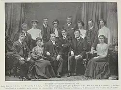 A black and white picture of fourteen members of the Victoria University College Students Association Committee in 1904.