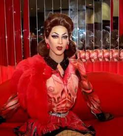 Photograph of a drag performer wearing a red outfit