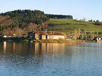 lake with house near a mountain