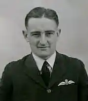 Head-and-shoulders portrait of man in dark uniform with pilot's wings