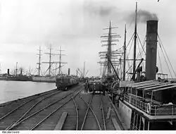 Wallaroo jetty in 1909, showing shipping, launches, and grain waiting for loading.