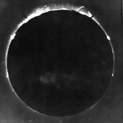 A black-and-white photograph of a total solar eclipse