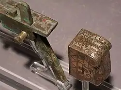 Warring States or Han dynasty crossbow trigger and buttplate made of bronze and inlaid with silver.