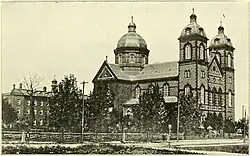 An old looking picture of a large church