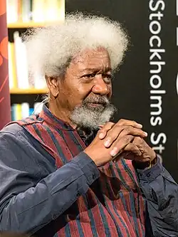 Head and shoulders of an aged black man, with a full head of white hair. He has a medium-sized moustache.