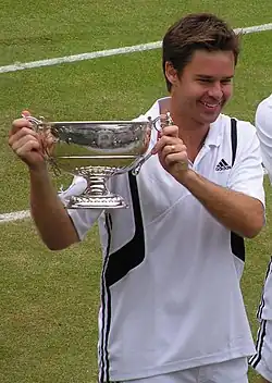 Image 62Todd Woodbridge holding the Gentlemen's doubles silver challenge cup in 2004 (from Wimbledon Championships)