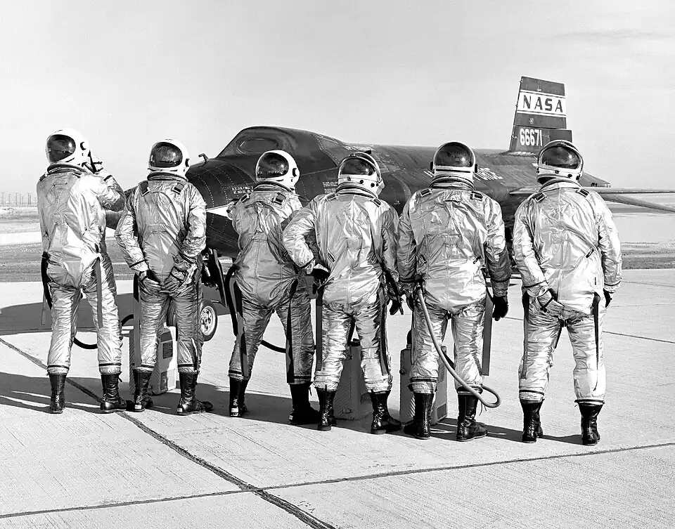 The X-15 pilots clown around in front of the #2 aircraft. From left to right: Joseph Engle, Robert Rushworth, John McKay, William Knight, Milton Thompson, and William Dana.
