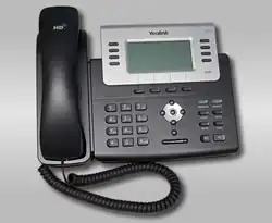 A black and grey corded phone with LCD display
