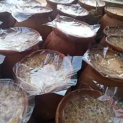 Sweet yoghurt, made and contained in pots of clay are kept for sale, Bangladesh.