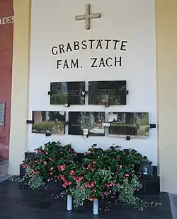 The tombstone of Hilde Zach decorated with photos and flowers