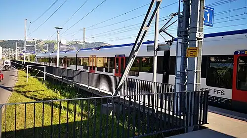 Red-and-white train at side platform
