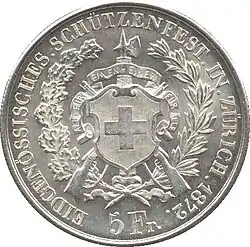Swiss shield superimposed over fasces, crossed rifles and banner reading "ALLE FÜR EINEN – EINER FÜR ALLE", translated as "all for one, one for all". Surrounded by wreath of oak and laurel. Legend and date along edge. Denomination below.